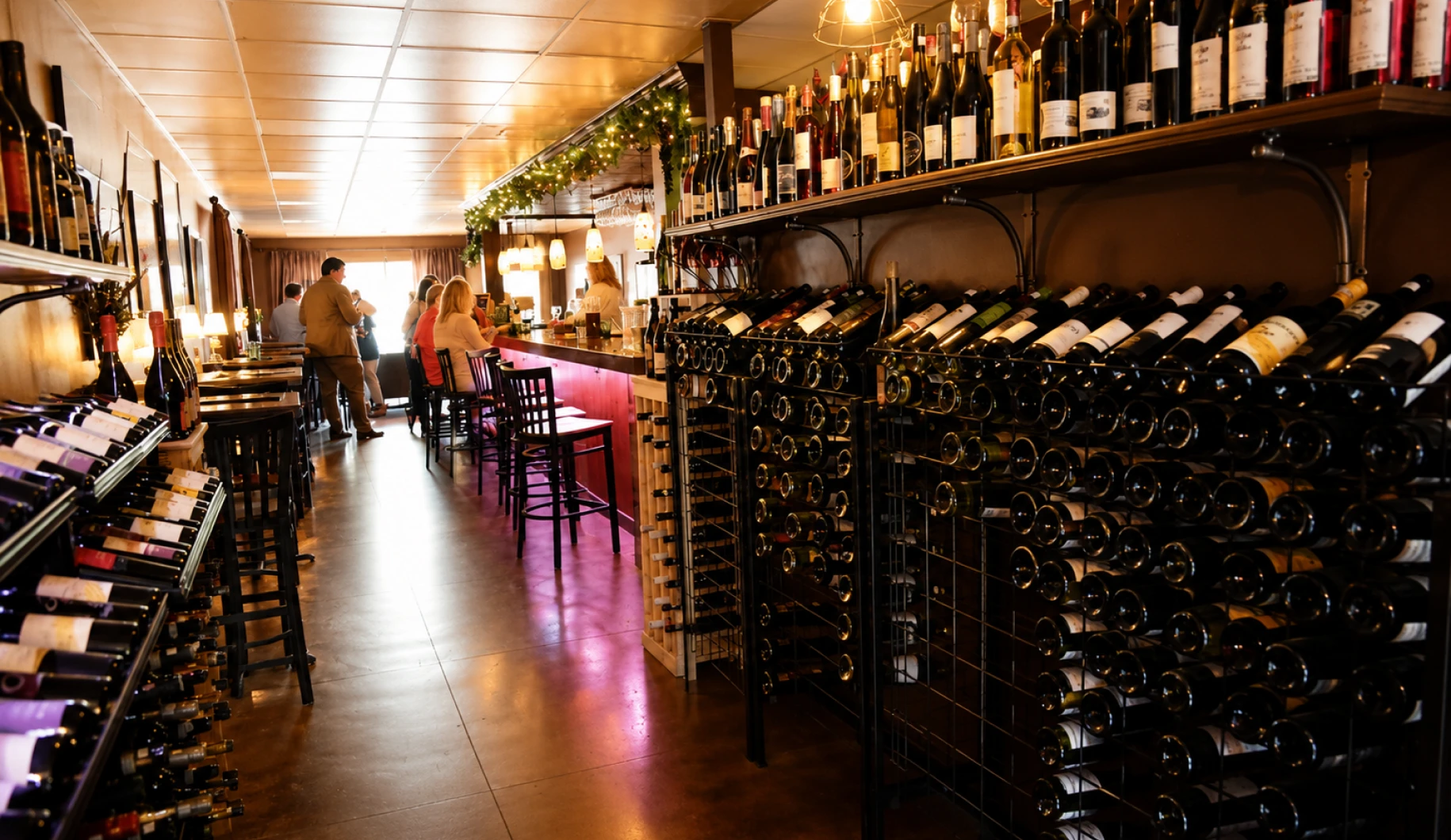 Wine bar with bottles and patrons inside.