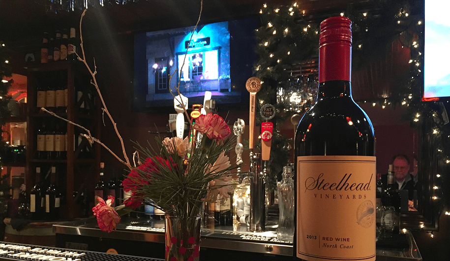Wine bottle on decorated bar counter.