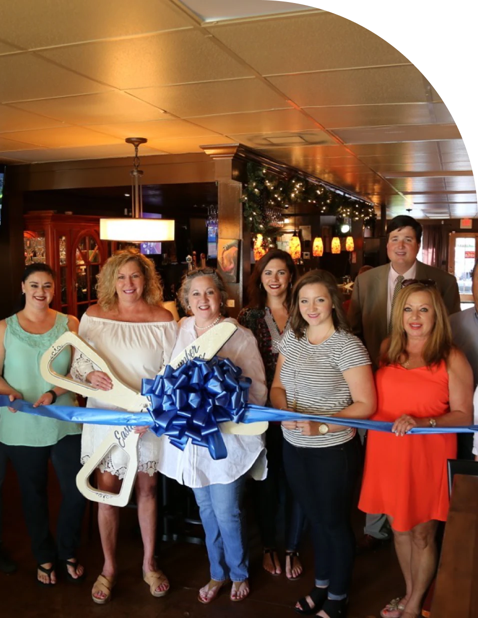 Group at ribbon-cutting ceremony with scissors.