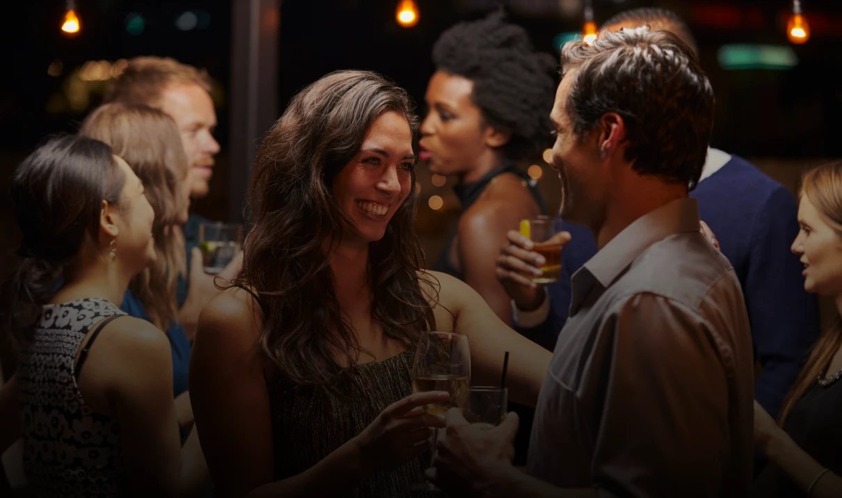 People socializing at a lively evening party.